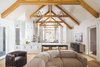 Modern home with Living Room, Sectional, Console Tables, Ceiling Lighting, Pendant Lighting, Medium Hardwood Floor, Sofa, and Chair. Athens Living Space Photo 7 of Athens Home