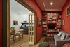 Modern home with Living Room, Sofa, Coffee Tables, Ceiling Lighting, Medium Hardwood Floor, Rug Floor, and Bookcase. Reading room. Photo 6 of Drake House