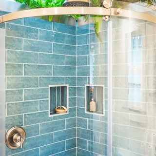 A skylight and live plants in the bathroom shower supply the feeling of bathing outdoors. 