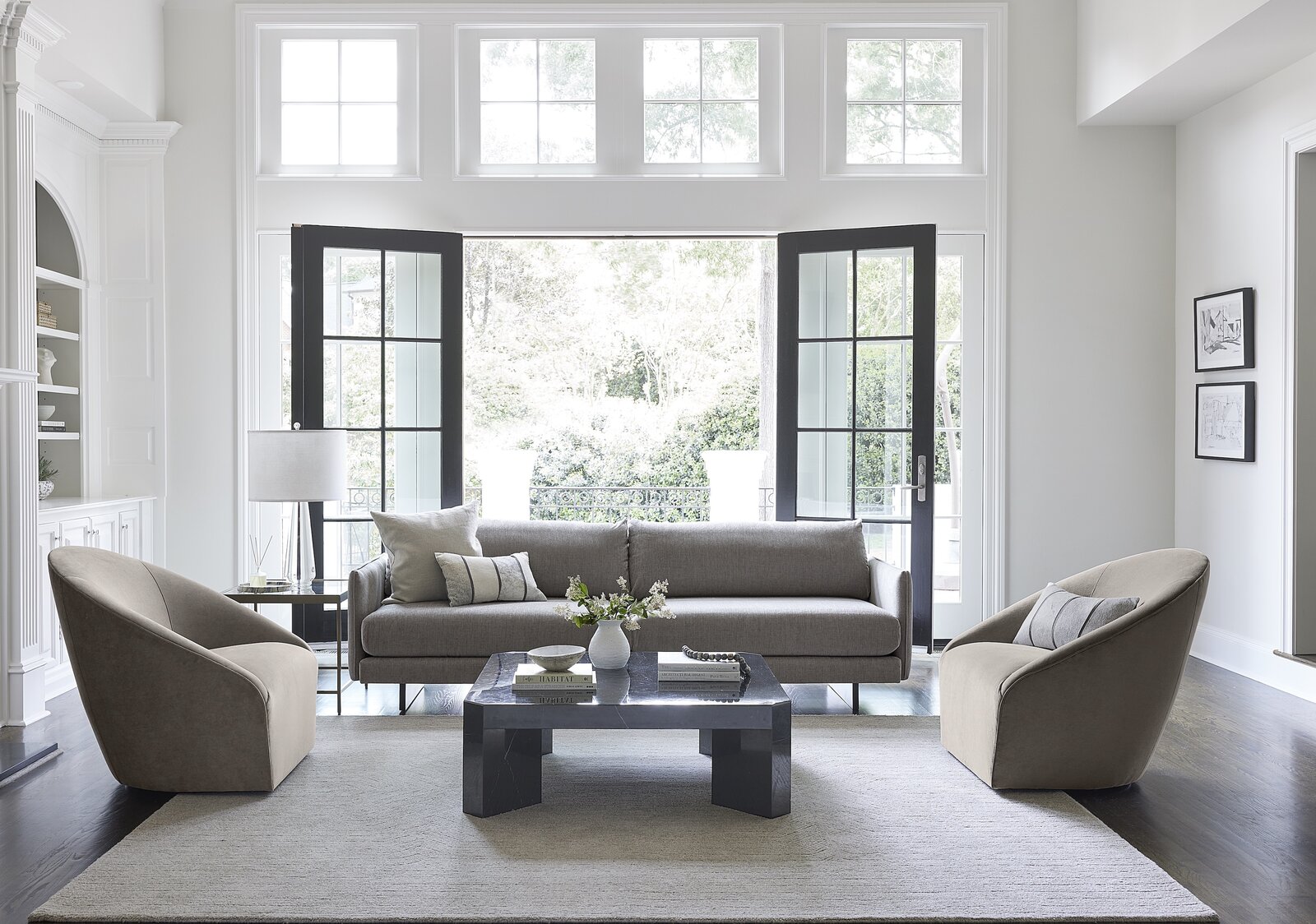 Living Room, Chair, Table Lighting, Coffee Tables, and Sofa Dynamic spaces invite conversations and moments for relaxation. Shown here, the Soma Sofa plays with perspective— featuring thin arms and an overscaled back. The clean lines pair well with the accentuated curve of the the Rose Swivel Chair, pictured above in a mushroom performance luxe velvet.  Photo 3 of 6 in Clean-Lined Appeal Defines Mitchell Gold + Bob Williams’ Fall Collection