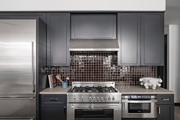 O'Donnell spruced up the kitchen with new cabinet fronts painted black and a glossy, chocolate brown backsplash.