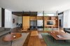 Modern home with Living Room, Dark Hardwood Floor, Pendant Lighting, Sofa, Bench, Coffee Tables, Chair, Gas Burning Fireplace, and Bookcase. living room Photo of Pindaibeiras House