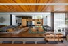 Modern home with Living Room, Pendant Lighting, Bench, Dark Hardwood Floor, Coffee Tables, Gas Burning Fireplace, Chair, Sofa, and Bookcase. living room and veranda Photo 2 of Pindaibeiras House