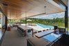 Modern home with Outdoor, Back Yard, Hanging Lighting, Large Pools, Tubs, Shower, Swimming Pools, Tubs, Shower, Infinity Pools, Tubs, Shower, Stone Patio, Porch, Deck, Metal Fences, Wall, Wire Fences, Wall, and Trees. veranda and pool Photo 8 of Pindaibeiras House