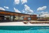 Modern home with Outdoor, Large Pools, Tubs, Shower, Shrubs, Gardens, Swimming Pools, Tubs, Shower, Hanging Lighting, Landscape Lighting, Grass, Stone Patio, Porch, Deck, Trees, and Large Patio, Porch, Deck. veranda and pool Photo 7 of Pindaibeiras House