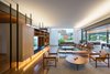 Modern home with Living Room, Bench, Bookcase, Chair, Sofa, Coffee Tables, Gas Burning Fireplace, Pendant Lighting, and Dark Hardwood Floor. living room Photo 18 of Pindaibeiras House