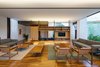 Modern home with Living Room, Bench, Sofa, Chair, Coffee Tables, Dark Hardwood Floor, Bookcase, Gas Burning Fireplace, and Pendant Lighting. living room Photo 19 of Pindaibeiras House
