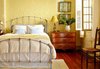 Modern home with Bedroom, Bed, Table Lighting, Ceiling Lighting, Chair, Dresser, and Medium Hardwood Floor. The master bedroom with it's own balcony overlooking the courtyard fountain Photo of Antoine Bordeaux House