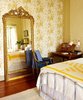 Modern home with Bedroom, Dresser, Bed, Wardrobe, Medium Hardwood Floor, Ceiling Lighting, and Table Lighting. New Orlean's style antiques throughout the home. Photo 4 of Antoine Bordeaux House