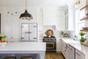 Bringing the perfect blend of traditional design and contemporary flair, the kitchen features Big Chill's Classic Fridge in White with Satin Nickel trim, Big Chill's Classic Dishwasher in White with Brushed Brass trim and Big Chill's 36" Classic Stove in Custom Basalt Gray with Brushed Brass trim. Photo 4 of Stunning Kitchen Renovation by House of Jade modern home