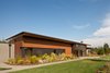 Modern home with Exterior, Flat RoofLine, Farmhouse Building Type, Wood Siding Material, Stone Siding Material, House Building Type, Metal Roof Material, and Concrete Siding Material. Olympia Prairie Home exterior Photo 8 of Olympia Prairie Home