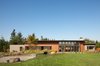 Modern home with Exterior, House Building Type, Flat RoofLine, Metal Roof Material, Stone Siding Material, Farmhouse Building Type, Wood Siding Material, and Concrete Siding Material. Olympia Prairie Home exterior Photo 5 of Olympia Prairie Home