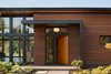Modern home with Exterior, Flat RoofLine, Farmhouse Building Type, Stone Siding Material, Concrete Siding Material, House Building Type, Metal Roof Material, and Wood Siding Material. Olympia Prairie Home entryway Photo 3 of Olympia Prairie Home