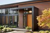 Modern home with Exterior, Flat RoofLine, Concrete Siding Material, House Building Type, Wood Siding Material, Stone Siding Material, Farmhouse Building Type, and Metal Roof Material. Olympia Prairie Home entryway Photo 4 of Olympia Prairie Home