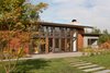 Modern home with Exterior, Flat RoofLine, Metal Roof Material, Farmhouse Building Type, Stone Siding Material, Concrete Siding Material, House Building Type, and Wood Siding Material. Olympia Prairie Home exterior Photo 9 of Olympia Prairie Home