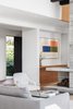 Modern home with Living Room, Chair, Sofa, Wood Burning Fireplace, Recessed Lighting, Coffee Tables, and Medium Hardwood Floor. Living room view towards Entryway Photo of Vancouver Island Residence