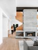Modern home with Living Room, Recessed Lighting, End Tables, Wood Burning Fireplace, Medium Hardwood Floor, and Sofa. Living Room Stair Corridor Photo 8 of Vancouver Island Residence