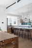 Modern home with Kitchen, Undermount Sink, Medium Hardwood Floor, Ceramic Tile Backsplashe, Pendant Lighting, Wood Cabinet, and Engineered Quartz Counter. Kitchen & Dining Area with Clerestory Photo 13 of Vancouver Island Residence