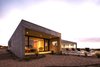Modern home with Exterior, House Building Type, Flat RoofLine, Concrete Siding Material, Beach House Building Type, and Stone Siding Material. The bedroom volume with it's private terrace and a landscape designed in accordance to the beach vegetation. Photo 4 of Pi House