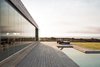 Modern home with Exterior, House Building Type, Glass Siding Material, Beach House Building Type, Concrete Siding Material, and Flat RoofLine. The terrace is closed with a mobile glass system that looks towards the pool. Photo 6 of Pi House