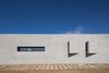 Modern home with Exterior, House Building Type, Concrete Siding Material, Flat RoofLine, and Beach House Building Type. The west facade designed very minimalistic, with only three very specific windows: the kitchen and the laundry. Photo 7 of Pi House
