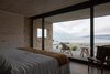 Modern home with Bedroom, Bed, Porcelain Tile Floor, Ceiling Lighting, and Chair. View from the master bedroom Photo 8 of Pi House