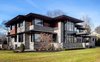 Modern home with Exterior, Hipped RoofLine, Shingles Roof Material, Stone Siding Material, Wood Siding Material, and House Building Type. Front Exterior Photo 2 of The Manhasset House