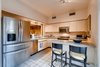 Modern home with Kitchen, Laminate Counter, Drop In Sink, Microwave, Track Lighting, Ceramic Tile Floor, Range, Dishwasher, Laminate Cabinet, and Refrigerator. Kitchen with original cabinets and countertops Photo 8 of Harrison Townhomes By Arquitectonica