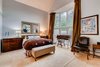 Modern home with Bedroom, Bed, Chair, Carpet Floor, Dresser, and Table Lighting. Top floor master bedroom suite Photo 10 of Harrison Townhomes By Arquitectonica