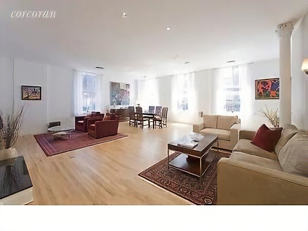 Before: While the loft had clear potential, awkward partitions (such as the one behind the couch on the right) prevented light from reaching the entire space.
