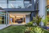 Modern home with Kitchen, Quartzite Counter, Laminate Cabinet, Cooktops, Wine Cooler, Microwave, Ice Maker, Wall Oven, Dishwasher, Refrigerator, Porcelain Tile Floor, Floor Lighting, Drop In Sink, and Ceiling Lighting. OPEN KITCHEN Photo 10 of RAINFOREST HOUSE