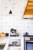 Modern home with Kitchen, Engineered Quartz Counter, White Cabinet, Wall Lighting, Undermount Sink, Wood Cabinet, Range, and Mosaic Tile Backsplashe. Hand made cement tiles with a custom pattern reflecting the sun and moon and a custom hood vent made of Laurel wood. Photo 4 of Casa Brumas