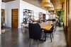 Modern home with Dining Room, Table, Gas Burning Fireplace, Ceiling Lighting, Concrete Floor, and Chair. The main feature in the dining room is the 12 ft table made from a single slab of Guanacaste wood. It was then transformed into a custom table for the home. Photo 5 of Casa Brumas