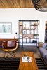 Modern home with Living Room, Chair, Ceiling Lighting, Bookcase, Concrete Floor, Sofa, and Coffee Tables. Most of the art hung throughout the house are highlighting local artists and several of the pieces of furniture as well, like this chair that is carved from one piece of Guanacaste wood. Photo 8 of Casa Brumas
