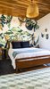 Modern home with Bedroom, Night Stands, Bed, Ceramic Tile Floor, and Ceiling Lighting. For this room we worked with a local illustrator and artist to paint a mural that is reflective of the surrounding nature. Photo 10 of Casa Brumas