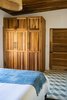 Modern home with Bedroom, Ceiling Lighting, Ceramic Tile Floor, and Bed. Closets custom designed and locally made as well as locally made cement tiles. Photo 11 of Casa Brumas