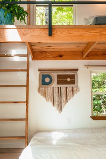 The bedroom nook features a hand-loomed tapestry by Jessica Sanchez, owner of Rusted Earth, which produces sustainable, handcrafted home decor "from the soil up". 