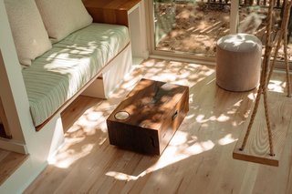 The black walnut coffee table slides into under the couch for additional floor space.