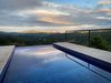 Modern home with Outdoor, Side Yard, Decking Patio, Porch, Deck, Small Pools, Tubs, Shower, Infinity Pools, Tubs, Shower, Concrete Pools, Tubs, Shower, Swimming Pools, Tubs, Shower, Trees, Metal Patio, Porch, Deck, Small Patio, Porch, Deck, Metal Fences, Wall, Landscape Lighting, and Wire Fences, Wall. 0. Tropical sunset at the pool Photo of Mountain House GetAway