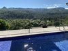 Modern home with Outdoor, Front Yard, Metal Fences, Wall, Vertical Fences, Wall, Wire Fences, Wall, Small Patio, Porch, Deck, Pavers Patio, Porch, Deck, and Trees. 2. Fire pit right off the Pool Deck to ambiance out a tropical evening, roast marshmallows or just entertain friends Photo 3 of Mountain House GetAway