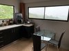 14. This open kitchen also features a breakfast table for four and serene views Photo 15 of Mountain House GetAway modern home