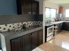 12. A well-equipped kitchen is a cook's dream with abundant cabinetry, spacious countertops and landscapes view Photo 13 of Mountain House GetAway modern home