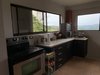 13. The kitchen is a cook's delight with a full size range, large microve, deep-frier and butler sink and there's a dining table for eight Photo 14 of Mountain House GetAway modern home