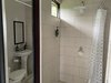 16. Light secondary bathroom with minimalistic design and tiled with white ceramic Photo 17 of Mountain House GetAway modern home