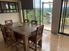 7. This rustic dining setup is part of a lounge-and-diner layout, which is anchored by the side of the home looking over mother nature's tropical creation Photo 8 of Mountain House GetAway modern home