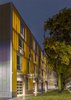 Modern home with Exterior, Apartment Building Type, Metal Siding Material, Glass Siding Material, Flat RoofLine, and Metal Roof Material. KLEO Art Residences, Exterior. The building literally glows and becomes a beacon within the community. Photo 2 of The KLEO Art Residences