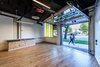 The community and artists’ spaces were designed with individual roll-up doors that allow artists to share their work and wares with the community. Photo 10 of The KLEO Art Residences modern home