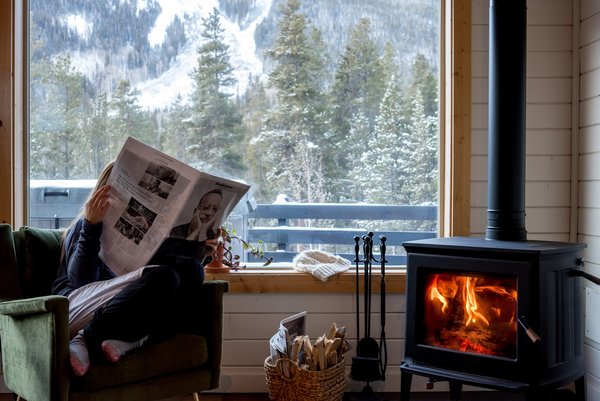 The DIY team replaced a noisy, burgundy pellet stove with a Vermont-made Hearthstone wood-burning stove, they created a cozy corner to guests to defrost from the Colorado cold.