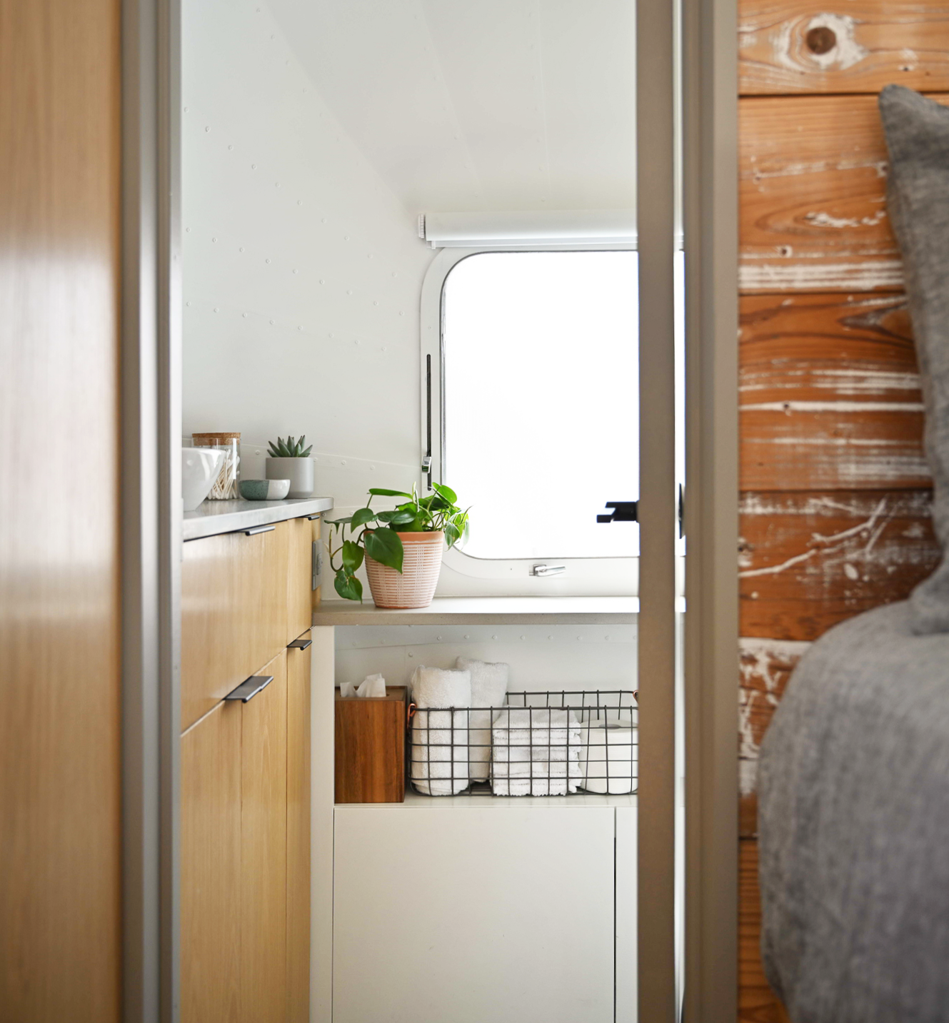 With the toilet and shower concealed by the door, the bathroom appears larger than its actual size.