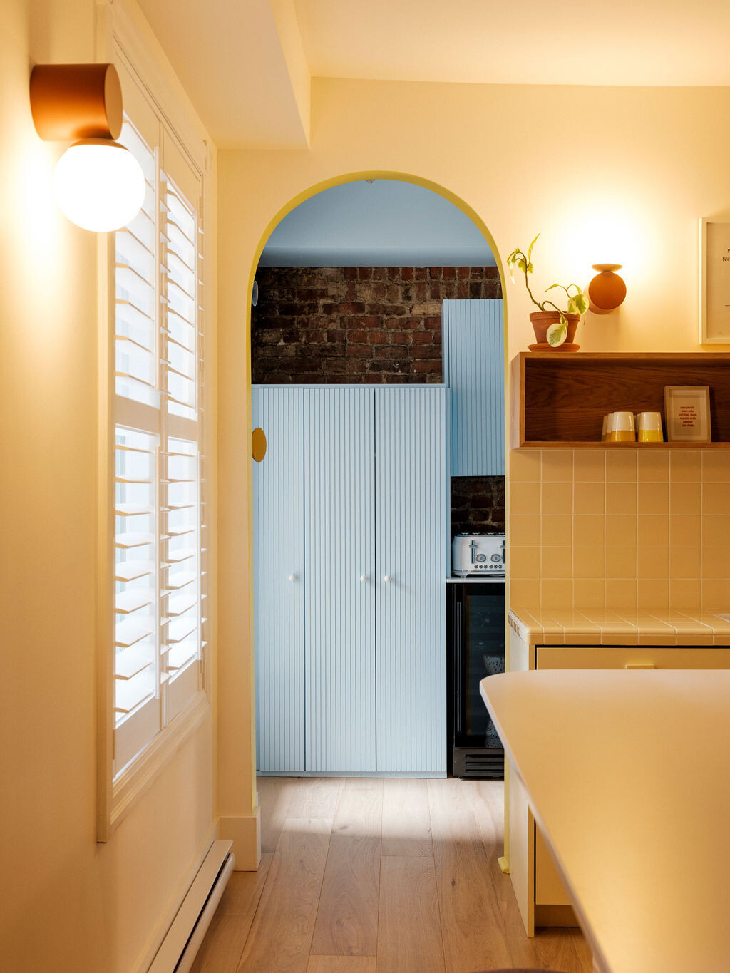 The oven and fridge are hidden out of the main area which creates extra workspace in the main room. A tiled hoot vent has a vintage-inspired charm. 
